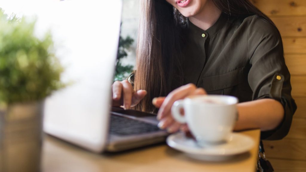 person blogging at a cafe